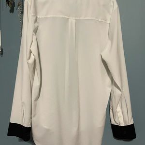 Black detailed, white dressy blouse.